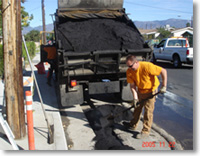 A man working on a city street asphalt project